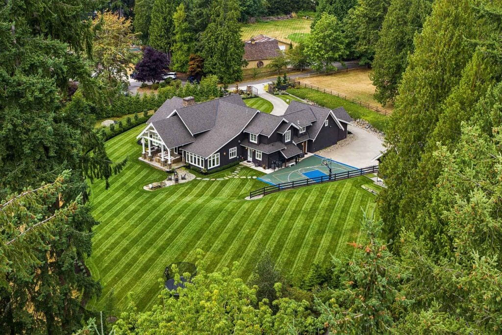 Woodinville Estate with large grass lawn and sport court.